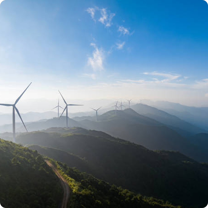 Wind turbines on a mountain landscape representing how energy is sourced