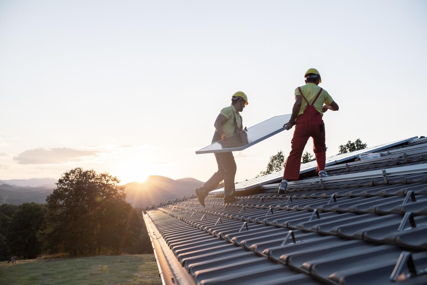 Workers installing rooftop solar panels